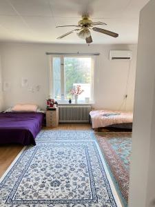 a room with two beds and a ceiling fan at Lägenhet/Apartment Krylbo, Avesta Sweden in Avesta
