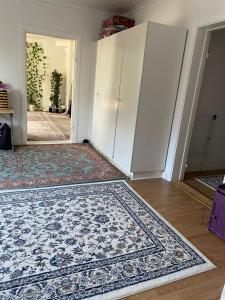 an empty room with a rug and an open door at Lägenhet/Apartment Krylbo, Avesta Sweden in Avesta