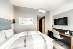 Postel nebo postele na pokoji v ubytování Premier Inn München City Ost
