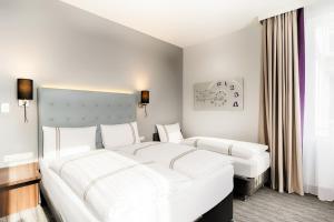 Postel nebo postele na pokoji v ubytování Premier Inn München City Ost