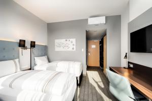 Postel nebo postele na pokoji v ubytování Premier Inn München City Ost