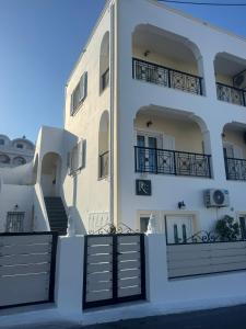 a large white building with stairs in front of it at Villa Tania R in Firostefani