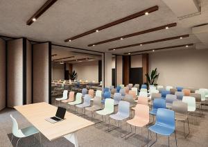 a conference room with a table and chairs and a laptop at INNSiDE by Meliá Madrid Valdebebas in Madrid