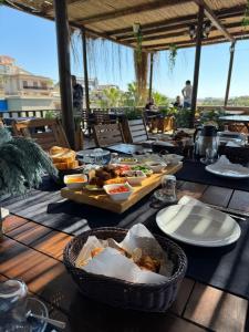 a table with plates of food on top at SEREN OTEL ÇEŞME in Cesme