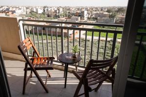 a table and two chairs on a balcony with a view at Modern 2 Bedroom Apartment with GYM&POOL in Lahore