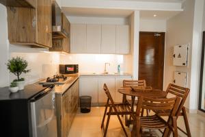 a kitchen with a table and chairs in a kitchen at Modern 2 Bedroom Apartment with GYM&POOL in Lahore