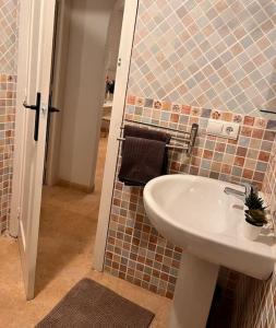 a bathroom with a sink and a tiled wall at Casa Rio in Rojales +14 photos
