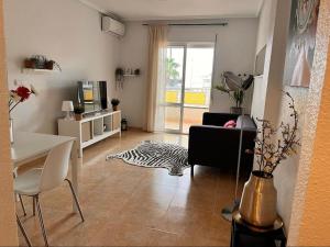 a living room with a table and a living room with a couch at Casa Rio in Rojales