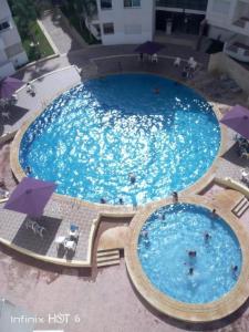 an overhead view of a large swimming pool at Bel Appartement à Bouznika in Bouznika
