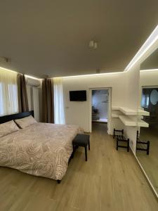 a bedroom with a bed and a desk and a television at Élite Etnea in Catania