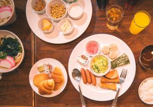 a wooden table with plates of food on it at APA Hotel Ueno Ekikita in Tokyo