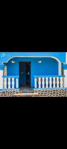 a blue building with a staircase and a door at CIDMAT VILLA in Freetown