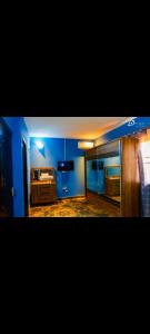 a room with blue walls and a bedroom with a bed at CIDMAT VILLA in Freetown