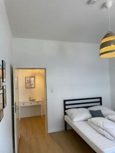 a bedroom with a bed and a hallway with a table at Schöne Erdgeschoss-Wohnung in Bremen in Bremen
