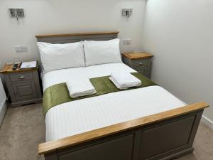 a bedroom with a large bed with two night stands at Wayfarers Lodge in Penzance