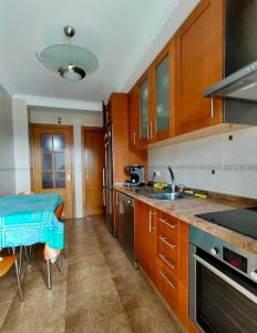 a kitchen with wooden cabinets and a counter top at Preciosas vistas en el corazón de la Riveira Sacra in Quiroga