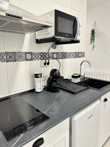 a kitchen with a sink and a microwave at Apartamentos Val de Comillas in Comillas