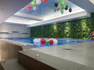 a swimming pool with balloons hanging from the ceiling at Costa Del Sol Hotel by Arabian Link in Kuwait