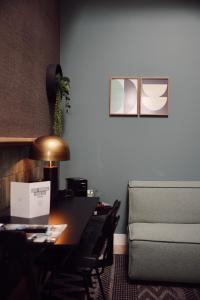 Pokój z biurkiem, kanapą i stołem w obiekcie Hotel Botanique Breda w mieście Breda