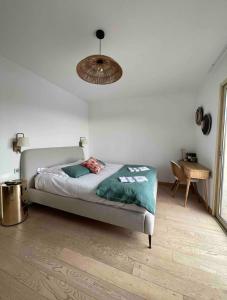 a bedroom with a bed and a lamp and a table at CHAMBRE D HOTE in Porticcio