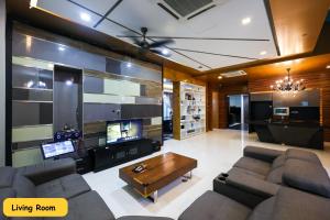 a living room with a couch and a table at 3 Storey Bungalow Event 20Px KL Setapak in Kuala Lumpur