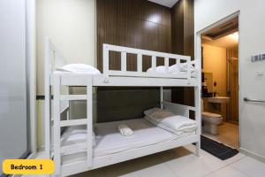 two bunk beds in a room with a bathroom at 3 Storey Bungalow Event 20Px KL Setapak in Kuala Lumpur