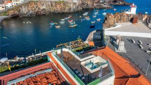 an aerial view of a harbor with boats in the water at Villa Belafonte in Câmara de Lobos