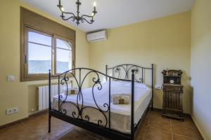 a bedroom with a bed and a clock and a window at HomeHolidaysRentals Karisma - Costa Barcelona in Argentona