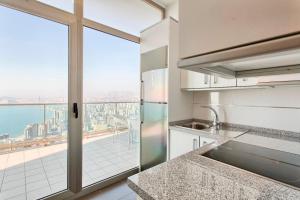 a kitchen with a large window and a view of the city at Luxury apartment on the 40th floor with amazing views in Benidorm