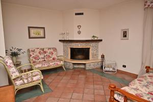 a living room with two chairs and a fireplace at Villa Irene in Mottola