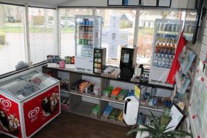 a store with a counter with drinks on it at Camping Engelbert (Groningen) in Groningen