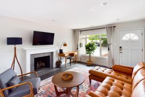 a living room with a couch and a fireplace at Santa Clara 3br w backyard ac nr park mall SFO-1564 in Santa Clara