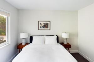 a white bedroom with a bed and two lamps at Santa Clara 3br w backyard ac nr park mall SFO-1564 in Santa Clara