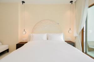 a bedroom with a white bed and a window at Emmarin Villa Pattaya in Nong Prue +67 photos