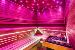 a purple sauna with a bench in a room at Hotel Savannah in Chvalovice