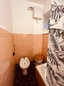 a bathroom with a toilet and a sink at Clio Apartment in Verbania