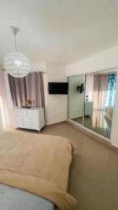 a bedroom with a bed and a large mirror at Appartamento Antille Juan Dolio fronte mare in Juan Dolio