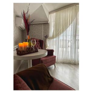 a living room with a table with candles and a couch at Buyukada Princess Hotel in Buyukada