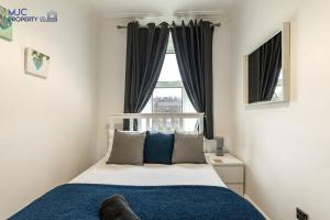 a bedroom with a bed and a window at River Teviot in Hawick