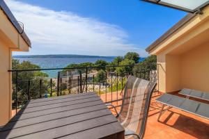 a balcony with a table and chairs and a view of the water at Beach Apartments Center in Crikvenica