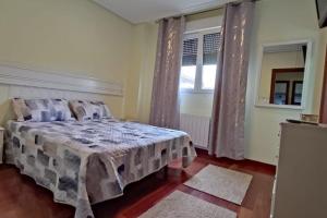 a bedroom with a bed and a window at Los acebos. Mar, montaña, cuevas in Rasines