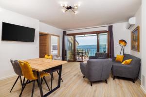 a living room with a dining room table and chairs at Beach Apartments Center in Crikvenica