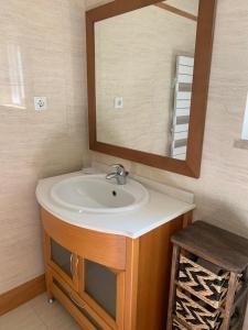 La salle de bains est pourvue d'un lavabo et d'un miroir. dans l'établissement Villa Luxsomar, à Charneca