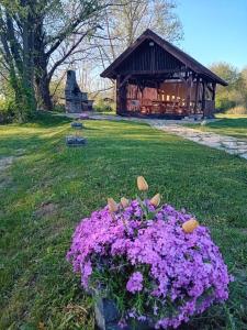 a pile of purple flowers in front of a cabin at Villa River and Sky in Bihać