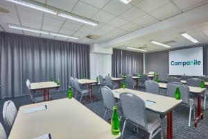 a conference room with tables and chairs and a screen at Campanile Katowice in Katowice