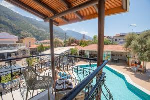 a balcony with a table and chairs and a pool at Bronze Hotel in Oludeniz