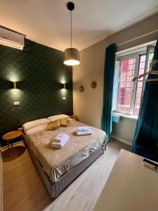 a bedroom with a bed with two towels on it at Hotel Domus Tiberina in Rome