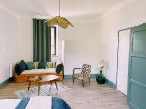 a living room with a couch and a table at CHATEAU D'APREMONT in Apremont