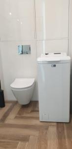 a white bathroom with a toilet and a sink at Active Residence C 408 in Lublin +18 photos