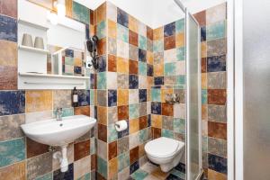 a bathroom with a sink and a toilet at Moja Accommodation in Kaunas +66 photos